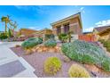 View of the home showcasing the desert landscaping with decorative rocks and greenery at 2069 King Mesa Dr, Henderson, NV 89012