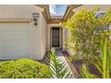 Inviting entryway with a covered porch, well-maintained landscaping, and visible house number at 2119 Lewiston Pl, Henderson, NV 89044