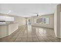 Bright and airy living room featuring a breakfast bar, tile flooring, and a sliding glass door at 2119 Lewiston Pl, Henderson, NV 89044