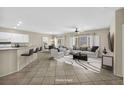 Bright living room with tile floors, neutral walls, and stylish furniture arrangement at 2119 Lewiston Pl, Henderson, NV 89044