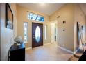 Bright foyer featuring tile flooring, decorative front door, and transom window at 2823 Landau Ct, Henderson, NV 89074