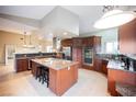 Updated kitchen with granite counters, center island, and stainless-steel appliances at 2823 Landau Ct, Henderson, NV 89074