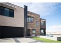 Stunning modern home with a black garage door and clean lines at 3530 S Spring Mountain Blvd Ct, Pahrump, NV 89048