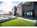 Striking modern home with a manicured lawn and glass doors at 3530 S Spring Mountain Blvd Ct, Pahrump, NV 89048