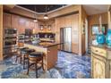 Modern kitchen features stainless appliances, granite countertops, and breakfast bar seating at 360 E Desert Inn Rd # 407, Las Vegas, NV 89109