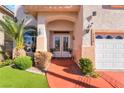 Close-up of front entrance featuring a double door and manicured landscaping at 4450 Zev Ct, Las Vegas, NV 89121