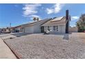 Well-maintained house featuring solar panels, desert landscaping, and a convenient two-car garage at 4571 Mcmillan Rd, Las Vegas, NV 89121