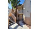 Inviting condo exterior with stairs leading to units, and palm trees at 5000 Red Rock St # 202, Las Vegas, NV 89118