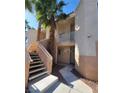 Inviting condo exterior with stairs leading to units, and palm trees at 5000 Red Rock St # 202, Las Vegas, NV 89118