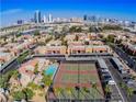 Aerial view of community featuring swimming pool, tennis courts, and city views at 5080 Indian River Dr # 398, Las Vegas, NV 89103