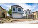 Charming two-story home featuring a two-car garage and desert landscaping at 637 N Water St, Henderson, NV 89015