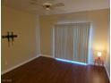 Spacious bedroom with hardwood floors, ceiling fan, and sliding glass doors for ample natural light at 7255 W Sunset Rd # 1171, Las Vegas, NV 89113