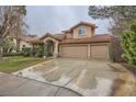 Charming front exterior showcasing the three car garage and cozy design at 8747 Vista Cantera Ct, Las Vegas, NV 89147