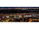Nighttime city view from balcony with ornate wrought iron railing at 9101 Alta Dr # 1206, Las Vegas, NV 89145