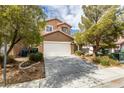 Charming two-story home with a well-manicured lawn, driveway, and a two-car garage in a residential neighborhood at 9529 Windsor Forest Ct, Las Vegas, NV 89123