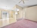 Bright living room featuring neutral walls, vintage carpet, a ceiling fan, and sliding glass doors at , Las Vegas, NV 89107
