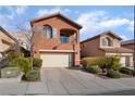 Inviting front exterior with a well-manicured lawn and a classic design, offers great curb appeal at 10858 La Florentina Ave, Las Vegas, NV 89166