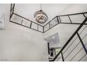 Open foyer with high ceilings, modern chandelier, views of the kitchen, and staircase at 10963 Mount Goyer St, Las Vegas, NV 89141