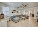 Inviting living room with neutral color palette, comfortable seating, and large windows for natural light at 10990 Mountain Willow St, Las Vegas, NV 89179