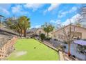 Expansive backyard featuring a putting green and ample space for recreation and outdoor enjoyment at 1312 Rolling Sunset St, Henderson, NV 89052