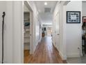 Hallway featuring wood floors, storage closet, and modern decor at 1410 Pink Dawn Dr, Henderson, NV 89014