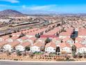 Stunning aerial view of neighborhood homes with a beautiful mountain view of the Las Vegas skyline at 1631 Lefty Garcia Way, Henderson, NV 89002