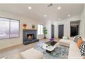 Bright living room with a brick fireplace, neutral decor, and ample natural light from the windows at 1820 Ann Greta Dr, Las Vegas, NV 89108