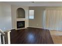 Living room with a fireplace, hardwood floors and sliding glass doors at 2105 William Holden Ct, Las Vegas, NV 89142