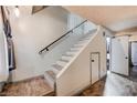 The interior shows a staircase with fresh paint and modern gray wood-look treads at 2641 Ruthe Duarte Ave, Las Vegas, NV 89121