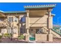 Charming two-story condo with landscaped yard, exterior stairs, and neutral stucco at 328 S Buffalo Dr # 101, Las Vegas, NV 89145