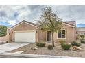 Charming single-story home featuring desert landscaping, a two-car garage, and a tile roof at 3305 Fernbird Ln, North Las Vegas, NV 89084