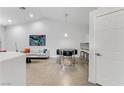 Bright dining area with modern table set, light gray sofa, and neutral tile floors at 3425 Conan St # 103, Las Vegas, NV 89129