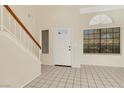 Bright foyer with tiled flooring, white front door with glass, and high ceilings with big windows at 409 Rutherford Cir, Las Vegas, NV 89123