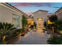 Inviting front entrance featuring manicured landscaping, decorative pots, and double doors at 4796 Riva De Romanza St, Las Vegas, NV 89135