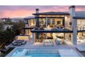 Expansive backyard featuring an in-ground pool, outdoor bar, generous patio seating, and manicured landscaping at 4918 Summit Overlook Dr, Las Vegas, NV 89135