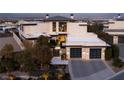 Modern home with a manicured front yard and a two-car garage featuring sleek doors with glass inserts at 4918 Summit Overlook Dr, Las Vegas, NV 89135