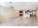 Spacious living room with tile floors, ceiling fan and neutral wall color at 5648 Alitak Bay St, North Las Vegas, NV 89081