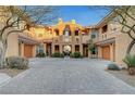 Attractive townhouse complex with multiple units, terra cotta roofs, garages, and desert landscaping at 820 Canterra St # 1054, Las Vegas, NV 89138