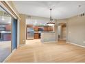 Bright living room with wood floors, sliding glass doors, and a view of the kitchen at 820 Canterra St # 1054, Las Vegas, NV 89138