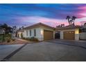 This single-story home features a three-car garage, gated entry and lush landscaping at 8211 Windsor Crest Ct, Las Vegas, NV 89123