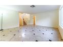 Spacious living room featuring tile floors, natural light, and staircase access to the second floor at 8217 Maplestar Rd, Las Vegas, NV 89128