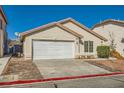 Single story home with neutral stucco, tile roof, rock landscaping, and a two car garage at 8728 Honey Vine Ave, Las Vegas, NV 89143