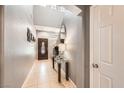 Bright entryway featuring a mirrored table, tiled flooring, and decorative accents at 9057 Mcginnis Ave, Las Vegas, NV 89148