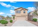 Two-story home with a beige exterior, complemented by a two-car garage and landscaped front yard at 108 Fiery Hill Ave, Henderson, NV 89011