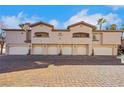 Attractive townhome showcasing multiple private garages and a colorful brick driveway on a sunny day at 108 Lemon Glaze St # 202, Las Vegas, NV 89145