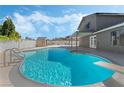 Inviting backyard pool featuring a diving board, attached hot tub, and privacy fencing at 1300 Oak Tree Ln, Las Vegas, NV 89108
