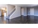 Open-concept space featuring a staircase, neutral color palette, and dark wood floors at 1416 Swanbrooke Dr, Las Vegas, NV 89144