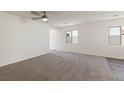 Spacious living room with neutral carpet and paint and large windows offering ample natural light at 1716 Desert Path Ave, North Las Vegas, NV 89032