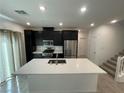 Bright kitchen featuring a large island, modern appliances, and dark cabinetry at 3669 Canis Minor Ln # 15101, Henderson, NV 89052