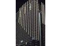 Striking high-rise building exterior at night featuring modern architectural design and dramatic lighting at 4381 W Flamingo Rd # 903, Las Vegas, NV 89103